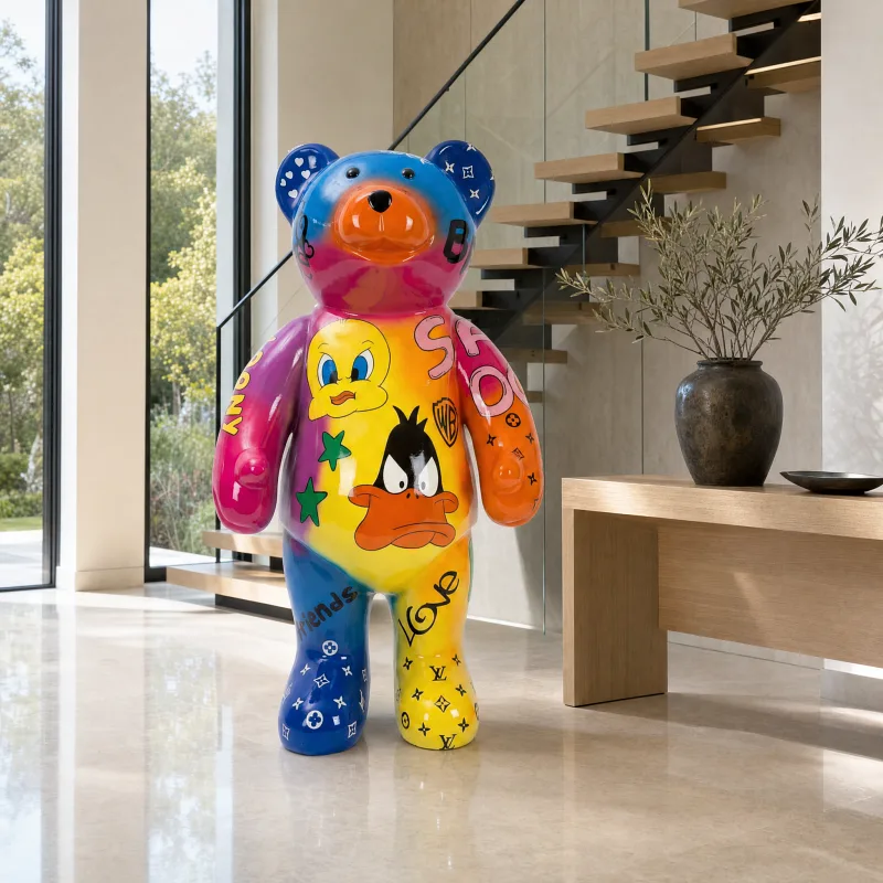 Bunte Bären-Skulptur mit Cartoon-Motiven in einem hellen Eingangsbereich mit Treppe